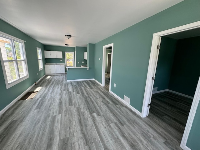 unfurnished living room with light hardwood / wood-style floors and a wealth of natural light