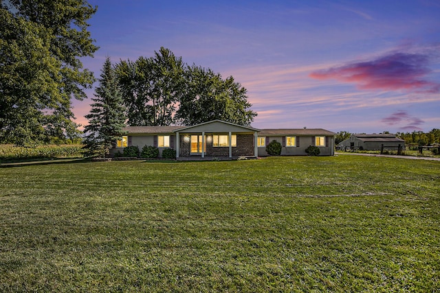 ranch-style house with a yard