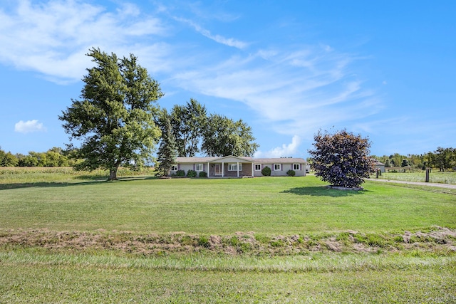 view of front of property with a front lawn and a rural view
