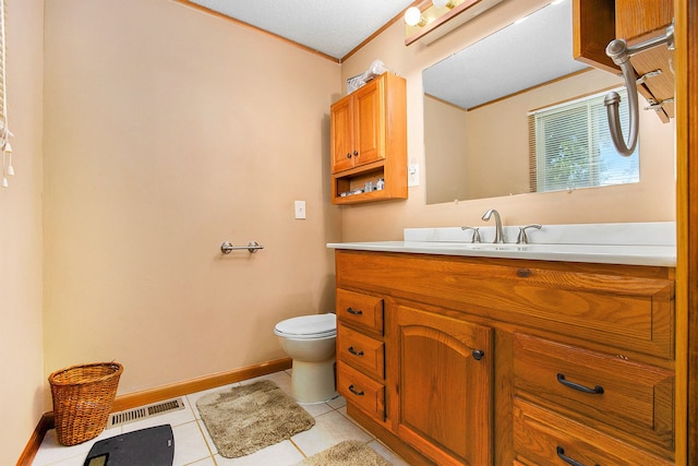 bathroom featuring tile patterned flooring, vanity, toilet, and a textured ceiling