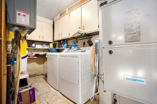 laundry area featuring cabinet space, independent washer and dryer, a textured ceiling, water heater, and heating unit