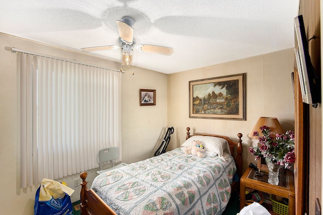 bedroom featuring ceiling fan and a textured ceiling