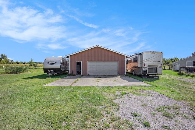 exterior space featuring a garage, an outdoor structure, and a lawn