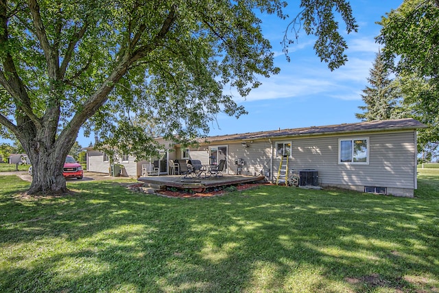 back of house with a lawn, cooling unit, and a wooden deck