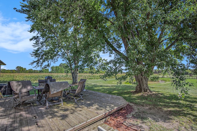 deck featuring a yard and a rural view