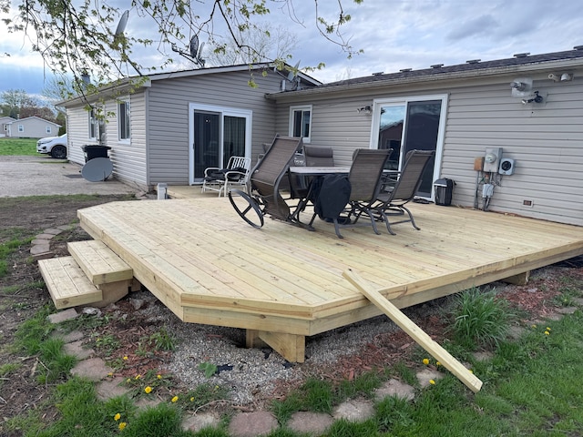 wooden terrace with outdoor dining space