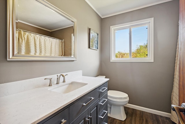 bathroom with vanity, toilet, wood-type flooring, and crown molding