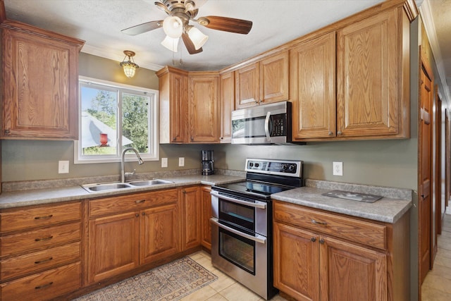 kitchen with a textured ceiling, stainless steel appliances, ceiling fan, sink, and light tile patterned flooring