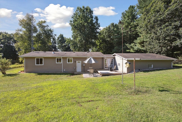 rear view of house with a lawn and a deck