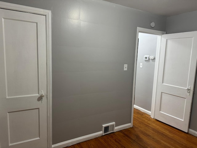 hallway with hardwood / wood-style flooring