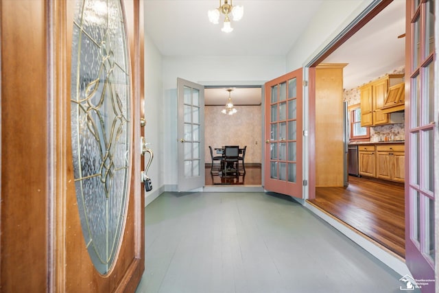 entryway featuring french doors and an inviting chandelier