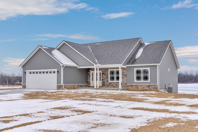 view of front of house with central AC unit and a garage