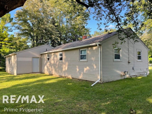 rear view of house featuring a yard