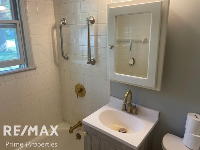 full bathroom featuring vanity, toilet, and tiled shower / bath