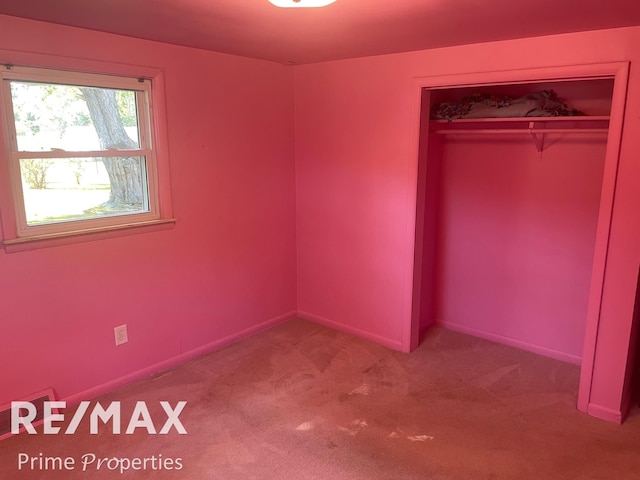 unfurnished bedroom featuring a closet and carpet floors