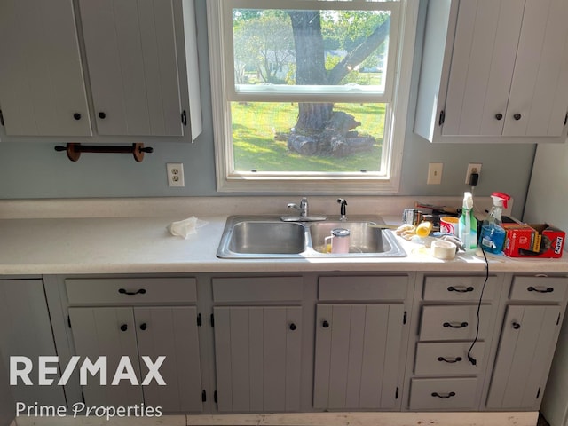 kitchen with white cabinetry and sink