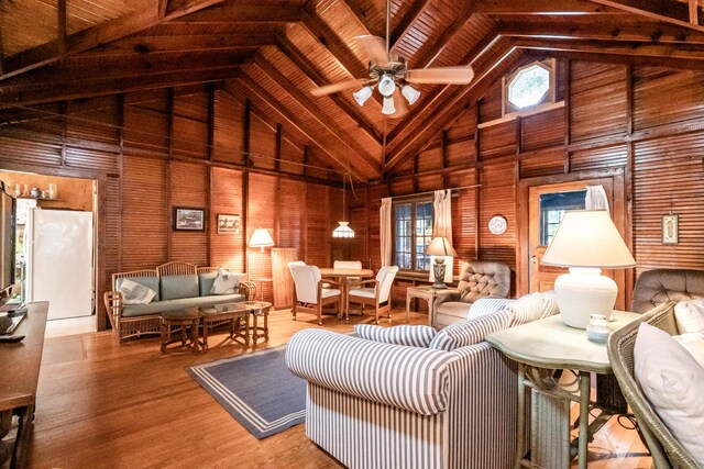 5212 Pier Rd, Coloma, MI 49038 - living room featuring high vaulted ceiling, wood walls, a ceiling fan, wooden ceiling, and wood finished floors