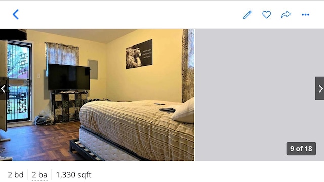 bedroom with dark parquet flooring and electric panel