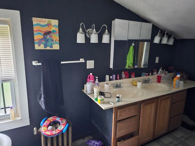 bathroom featuring vanity, a textured ceiling, and vaulted ceiling