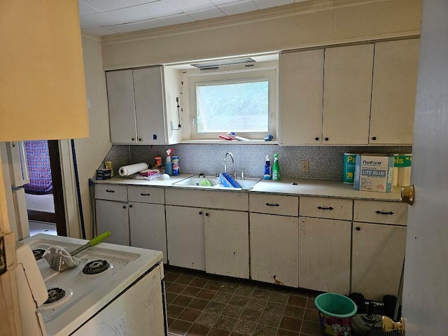 kitchen with white cabinets, electric stove, sink, and ornamental molding