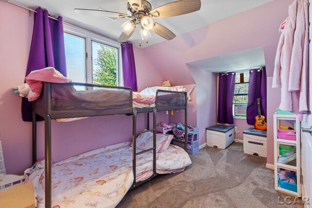 carpeted bedroom featuring multiple windows, ceiling fan, cooling unit, and vaulted ceiling