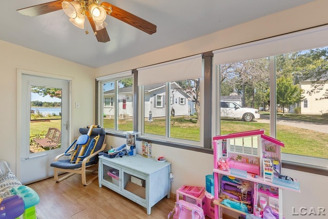 sunroom / solarium featuring ceiling fan and a healthy amount of sunlight