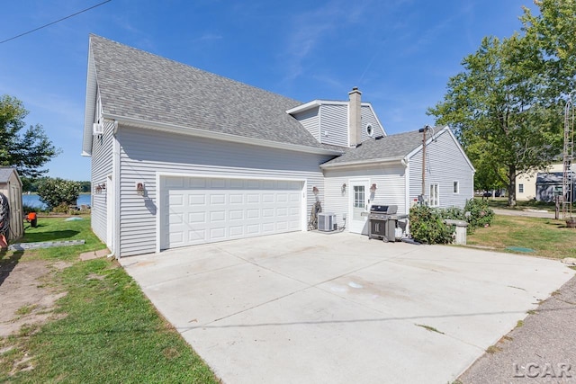 view of property exterior featuring central air condition unit and a garage