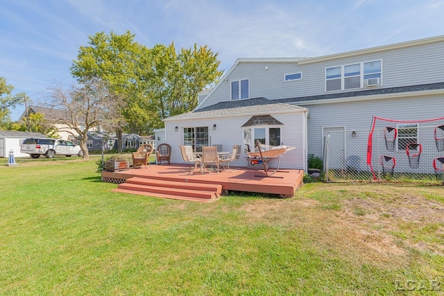 rear view of house with a lawn and a deck