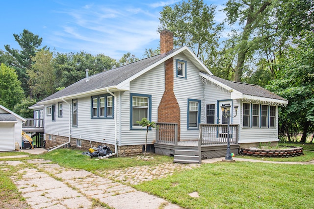 view of front of home with a wooden deck, a sunroom, and a front yard