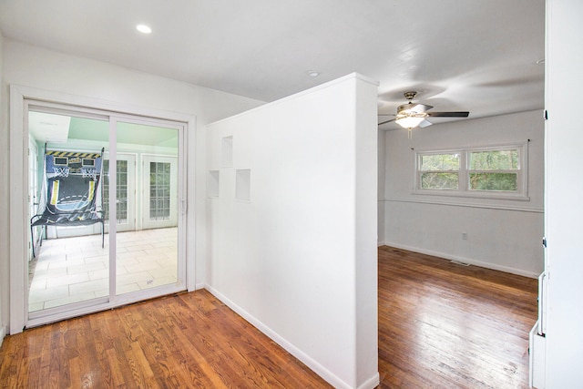 empty room featuring wood-type flooring and ceiling fan