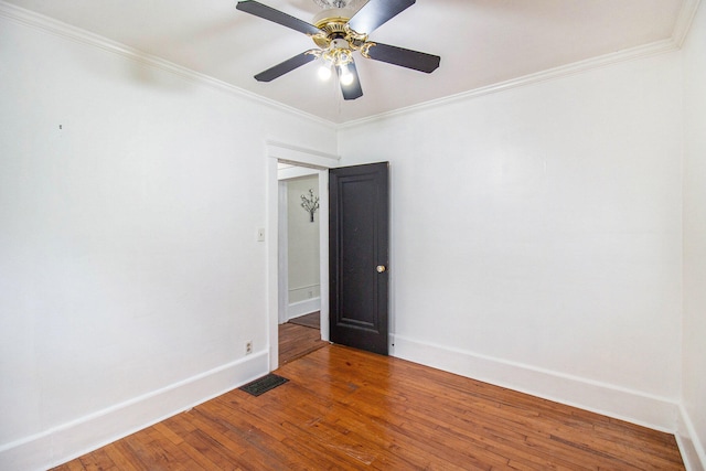 empty room featuring hardwood / wood-style floors, ceiling fan, and crown molding