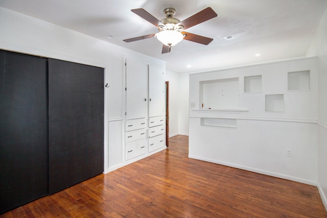 unfurnished bedroom featuring ceiling fan and dark hardwood / wood-style flooring