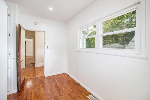 spare room featuring dark hardwood / wood-style flooring