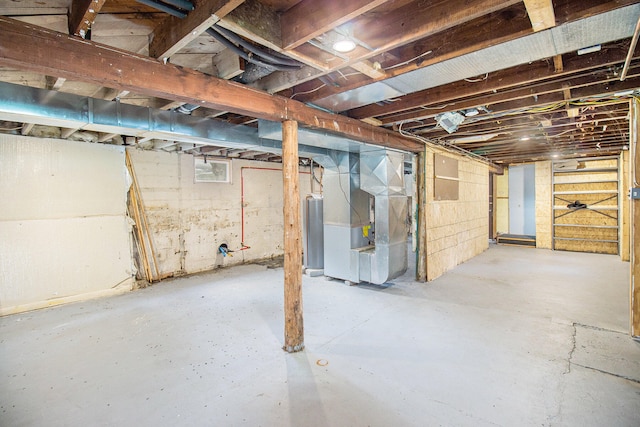 basement featuring heating unit and water heater