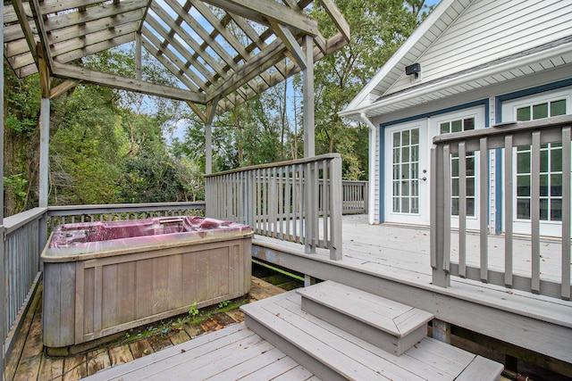 wooden deck featuring a pergola and a hot tub