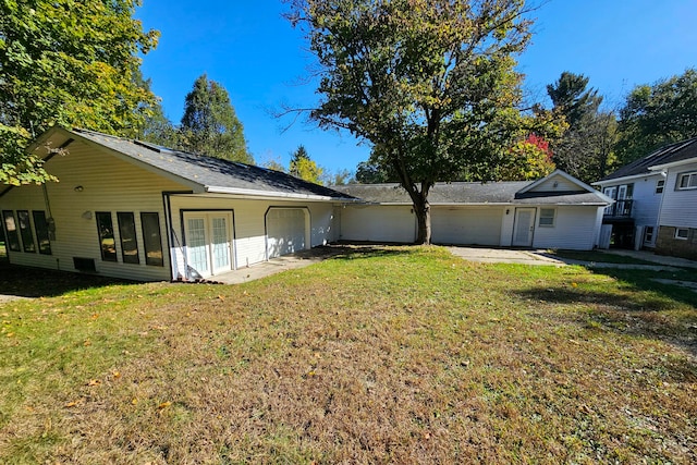 exterior space with a yard and a garage