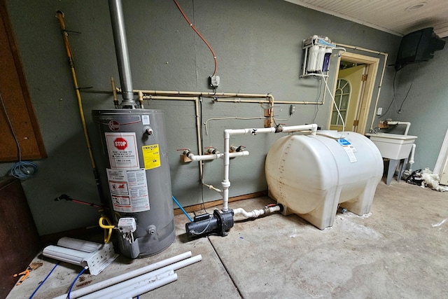 utility room featuring gas water heater and sink