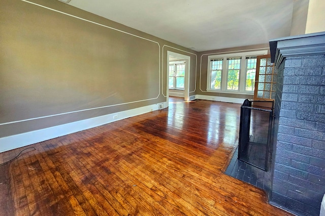 unfurnished living room featuring a fireplace and wood-type flooring