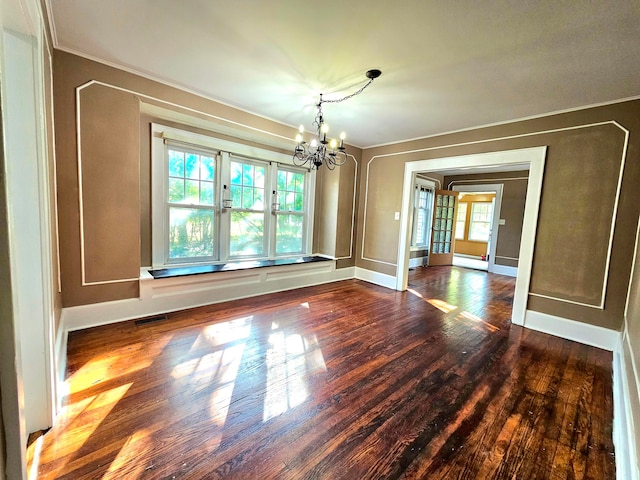 unfurnished dining area featuring dark hardwood / wood-style floors, a healthy amount of sunlight, and a notable chandelier