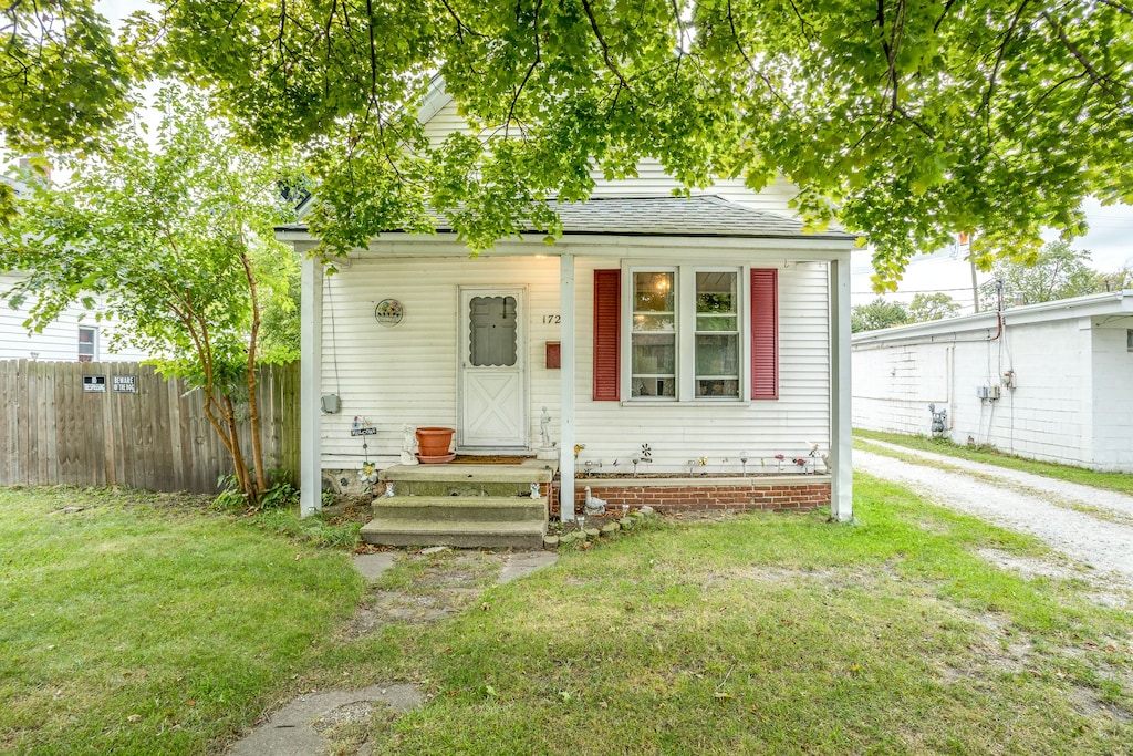 bungalow-style home featuring a front yard