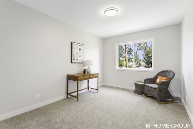 living area featuring light carpet