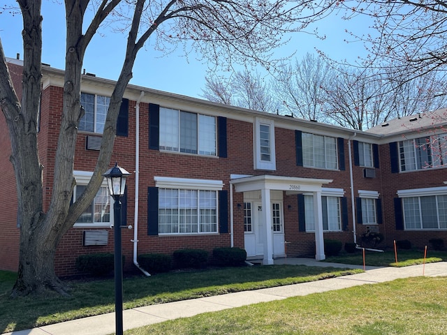 view of property featuring a front lawn