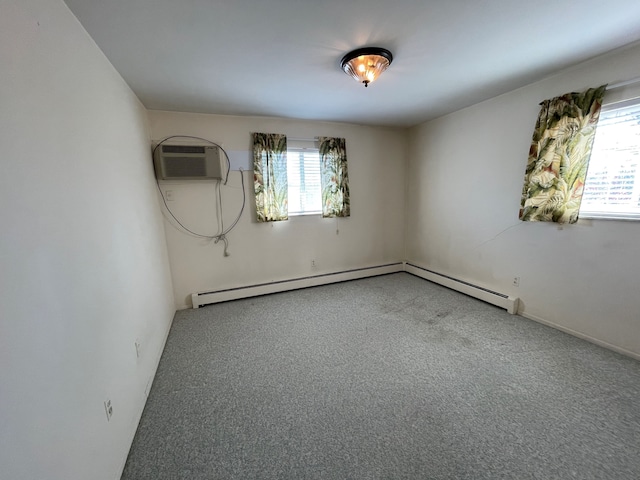 spare room with a wall mounted air conditioner, carpet floors, and baseboard heating