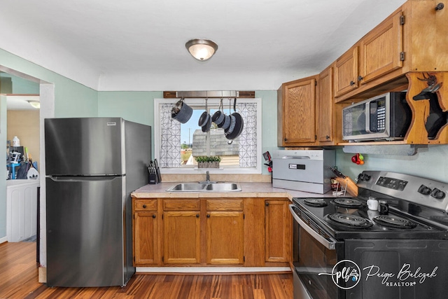 kitchen featuring sink, stainless steel appliances, and dark hardwood / wood-style floors