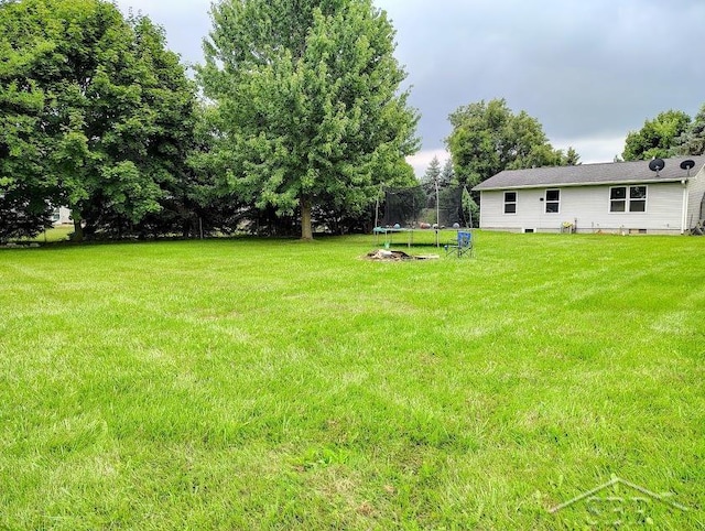 view of yard with a trampoline