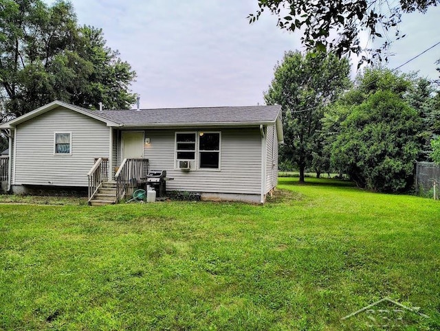 rear view of property with a lawn