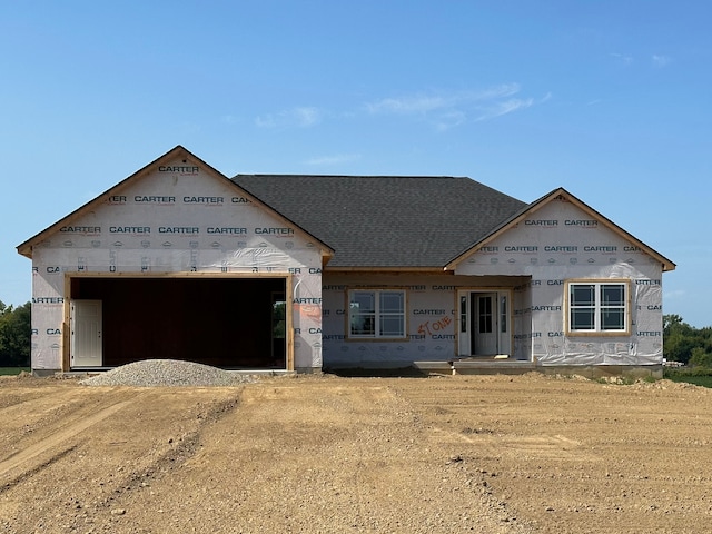 unfinished property featuring a garage