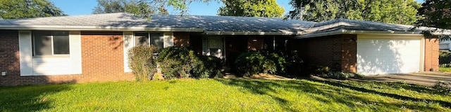 view of front of property with a front yard and a garage