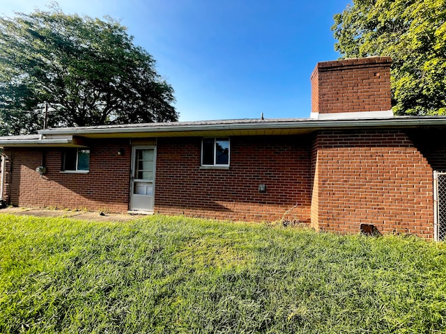 rear view of house with a lawn