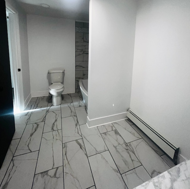 bathroom featuring baseboard heating and toilet